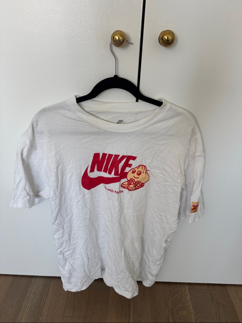 Nike White Tee with Red Logo and Cream Cartoon